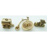 Three 9ct gold charms comprising penny farthing, caravan and a shoe, 8.5g