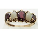 A 9ct gold ring set with oval cut garnets and opal cabochons, size N