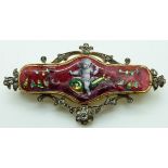 Victorian brooch set with red guilloché enamel depicting a cherub or putti, with rose cut diamonds