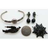 Two jet brooches, a pair of French jet earrings, Victorian love token and a bangle