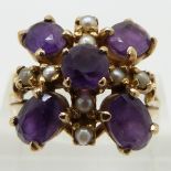 A 9ct gold ring set with oval amethysts and seed pearls, size R