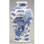 A 19thC Chinese small baluster vase decorated with two dogs of Fo and four character marks to