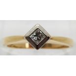 An 18ct gold ring set with a princess cut diamond in a platinum setting, size K
