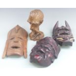 Three carved African masks and carved head, largest 32cm