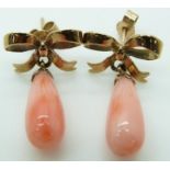 A pair of 9ct gold earring's in the form of bows with a pear drop coral bead to each