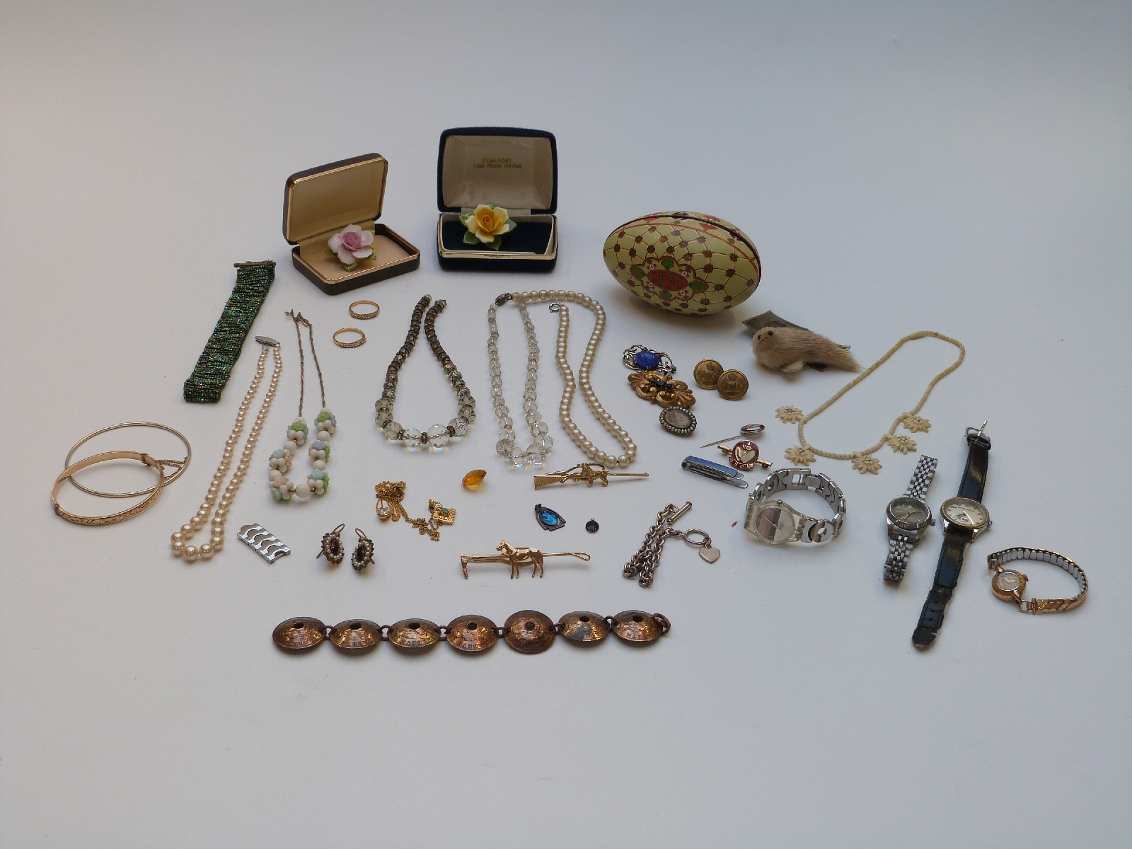 A collection of costume jewellery including glass necklace, Victorian brooch set with plaited