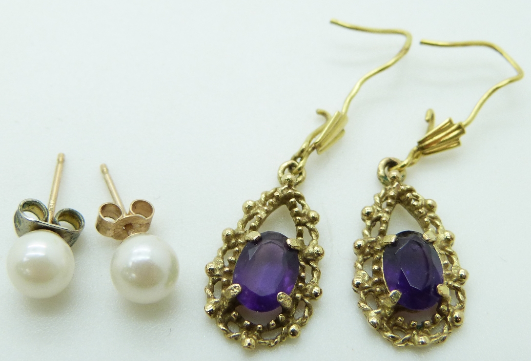 A pair of 9ct gold earrings set with amethysts and a pair of pearl earrings