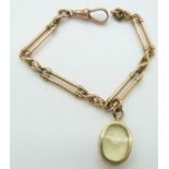 Victorian rose gold bracelet made up of elongated and knot links with a 9ct gold charm set with