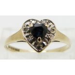 A 9ct gold ring set with a sapphire and diamonds in a heart shape, size O