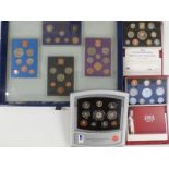 Royal Mint deluxe cased brilliant uncirculated millennium 2000 coin set together with a 1999 and