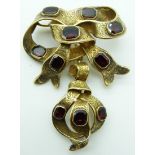 Victorian gold bow brooch set with foiled emerald cut garnets and chased detail in original fitted
