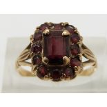 A 9ct gold ring set with garnets, size N
