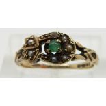 A 9ct gold ring set with an emerald and seed pearls