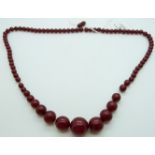 A graduated cherry amber necklace made up of round beads, 47g