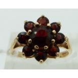 A 9ct gold ring set with garnets in a cluster, size N
