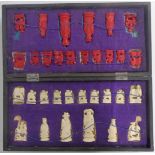 A 1920's Chinese carved bone chess set in original fitted lacquer box, height of king 7.5cm