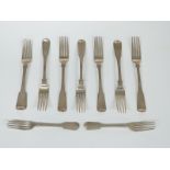 Nine Georgian fiddle pattern hallmarked silver forks comprising a set of six table forks, London