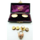 A pair of hallmarked 15t gold studs/ buttons in original box, four further 15ct gold studs, one by