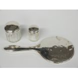 Hallmarked silver mounted hand mirror and two hallmarked silver lidded dressing table pots