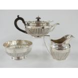 Victorian hallmarked silver tea set of squat lobed form, the boat shaped teapot London 1880, milk