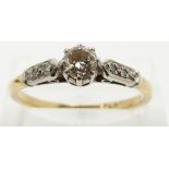 An 18ct gold ring set with a diamond of approximately 0.35ct in a platinum setting with diamond