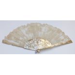 A 19thC mother of pearl and lace fan, the ornate pierced decoration set with white metal and gilt