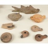 A quantity of ancient oil lamps including one example formed as a fish