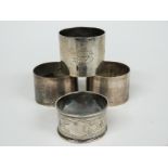 Four various hallmarked silver napkin rings including a pair of plain examples, weight 142g