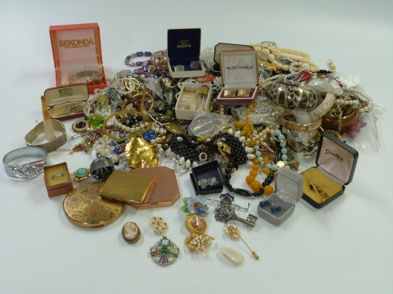 A collection of costume jewellery to include necklaces, earrings, brooches, compacts, Miracle brooch