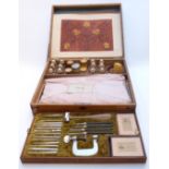A late 19thC/early 20thC French leather embossing kit in original wooden fitted case with lift out