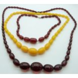 A cherry amber necklace and two amber style necklaces