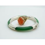 A silver and jadeite style bangle and silver gilt ring set with carved carnelian agate