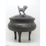 A bronze tripod censer / koro decorated with birds among bamboo friezes and with Dog of Fo finial,