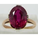 A 10ct gold ring set with an oval synthetic ruby, size Q