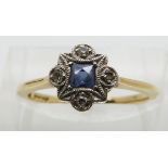 An 18ct gold ring set with a square cut sapphire and diamonds in a platinum setting, size K