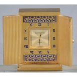 Mappin & Webb miniature gilt travel clock with doors opening to reveal a square face surrounded by