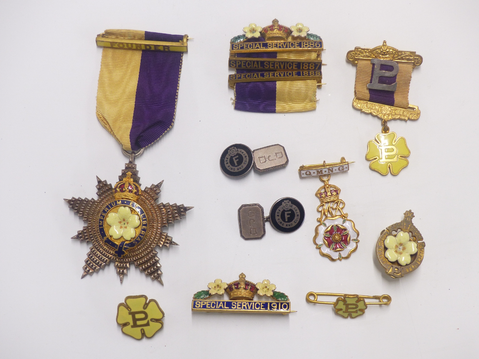 A collection of badges and a silver gilt medal all relating to Primrose club