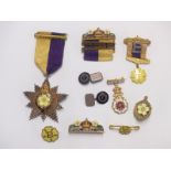 A collection of badges and a silver gilt medal all relating to Primrose club