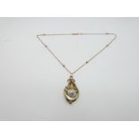 A 19thC pendant set with a natural pearl in an abstract shape and a 9ct rose gold beaded chain