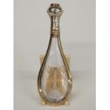 An 18th/19thC gilt white metal mounted glass tear drop shaped scent bottle, the lid set with eight