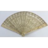 A 19thC Chinese ivory fan of 21 sticks, each with carved decoration of figures, dragons, boats