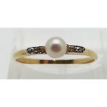Art Deco 18ct gold ring set with a pearl, with diamonds to the shoulders, size Q/R