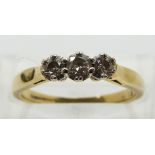 An 18ct gold ring set with three diamonds, total diamond weight approximately 0.25ct, size L