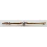 A 9ct gold bar brooch set with an old cut diamond measuring approximately 0.2ct