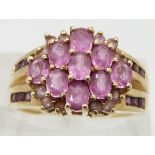 A 9ct gold ring set with pink sapphires, size P