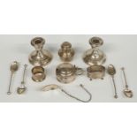 A quantity hallmarked silver items to include a pair of candlesticks, mustard, salt, two salt