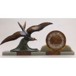 An Art Deco spelter and agate clock with sea bird decoration, sword hands and arabic numerals,