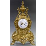 Louis XV style brass mantel clock the enamel Roman dial with filigree hands, the two train French