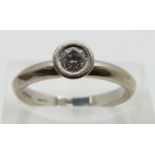 An 18ct white gold ring set with a round cut diamond of approximately 0.25ct, size N