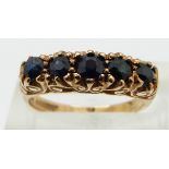 A 9ct gold ring set with five round cut sapphires, size K